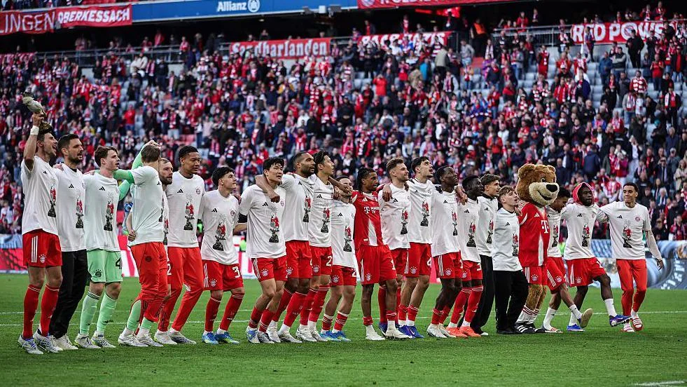 Bayern Munich players line up to celebrate winning the Bundesliga title
